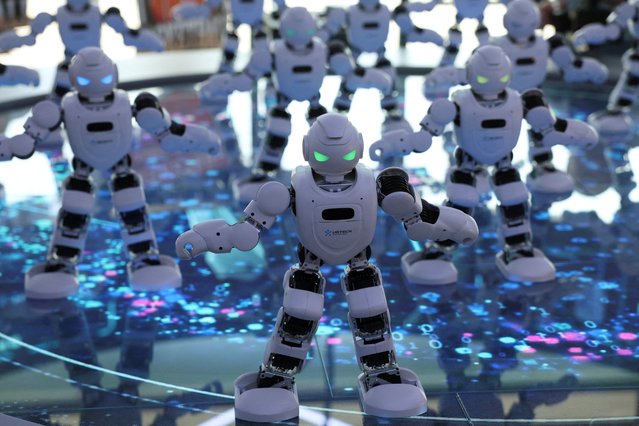 UBTECH Alpha robots perform a synchronized dance at Robot Mall in Beijing, China on August 6, 2025. (Photo by Florence Lo/Reuters)