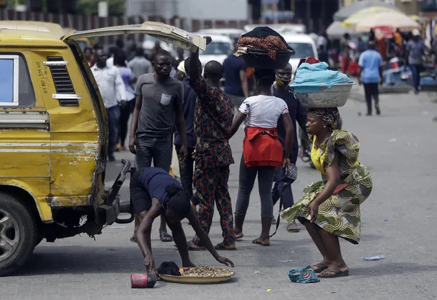 Passengers disembarked from a commercial bus in Lagos Saturday, October 24, 2020. (Photo by Sunday Alamba/AP Photo)