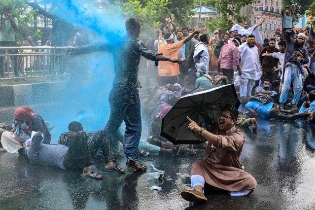 Bangladesh's police personnel use a water cannon to disperse demonstrators in Dhaka on June 22, 2025, during a protest by candidates of the 18th Non-Government Teachers' Registration Examination demanding a review of their viva results. (Photo by Munir Uz Zaman/AFP Photo)