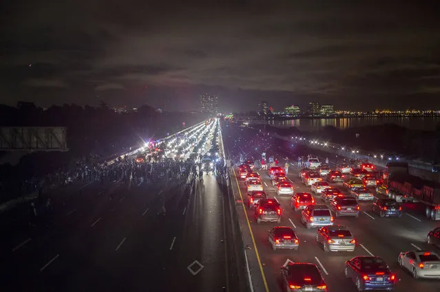 Protesters rallying against police violence block both directions of Interstate 80 in Berkeley, Calif., on Monday, December 8, 2014. (Photo by Noah Berger/AP Photo)