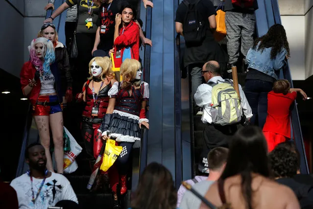 People dressed as Harley Quinn ride an escalator at New York Comic Con in Manhattan, New York, U.S., October 7, 2016. (Photo by Andrew Kelly/Reuters)