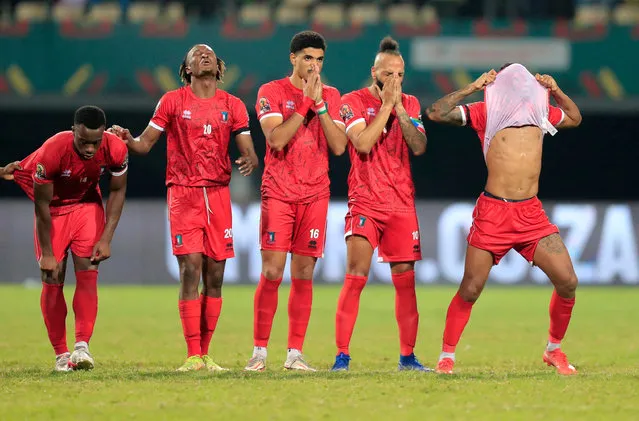 Santiago Eneme (second left) and his Equatorial Guinea teammates can’t watch during their last 16 penalty shoot-out with Mali, although they did go on to win at Limbe Omnisport Stadium in Limbe, Cameroon on January 26, 2022. (Photo by Thaier Al-Sudani/Reuters)