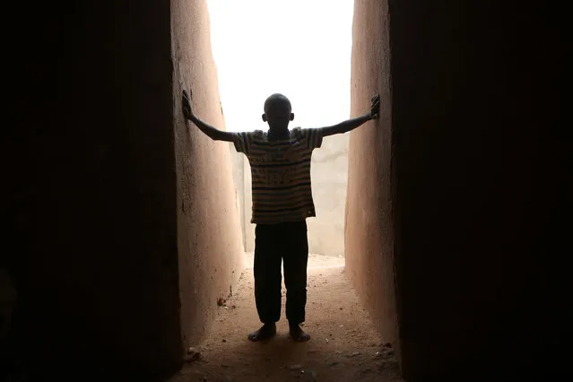 A boy stands in the doorway of a pyramid designed by Swiss architect Not Vital in Agadez, Niger, May 12, 2016. (Photo by Joe Penney/Reuters)