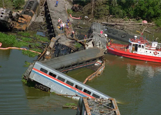 This September 22, 1993 file photo shows the wreckage of the Amtrak Sunset Limited train north of Mobile, Ala. A barge hit a railroad bridge and minutes later the train hit the bent tracks and plunged into the bayou, killing 47 people. (Photo by Mark Foley/AP Photo)