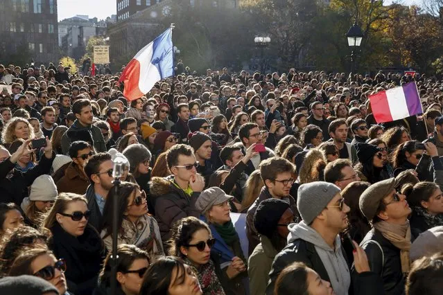 Mourners gather in response to attacks in Paris at Washington Square Park in the Manhattan borough of New York November 14, 2015. (Photo by Lucas Jackson/Reuters)