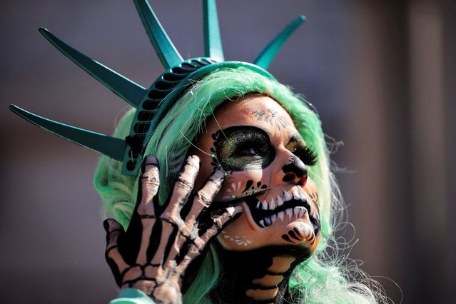 A protester wearing Catrina-inspired makeup and a Statue of Liberty-style headpiece takes part in a “No Kings” protest against U.S. President Donald Trump's policies, outside City Hall in Los Angeles, California, U.S., October 18, 2025. (Photo by Daniel Cole/Reuters)