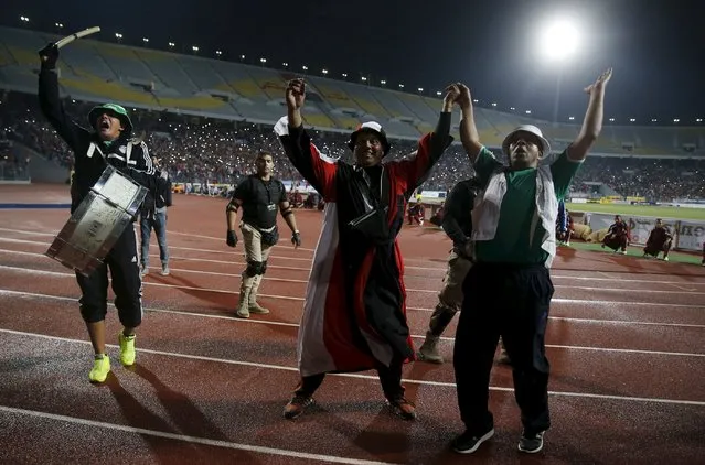 Egyptian fans cheer before 2018 World Cup qualifying soccer match against Chad, at the Borg El Arab "Army Stadium" in the Mediterranean city of Alexandria, north of Cairo, Egypt, November 17, 2015.The match is the first in a long time that will played with spectators after receiving approval from security. (Photo by Amr Abdallah Dalsh/Reuters)
