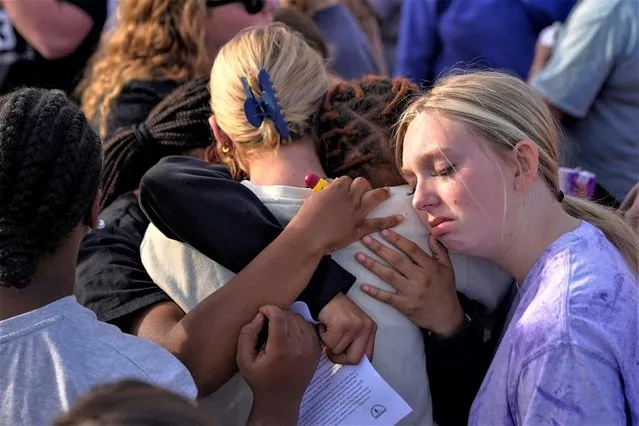 Community members embrace each other during a vigil the day after a shooting during a teenager's birthday party at Mahogany Masterpiece Dance Studio in Dadeville, Alabama, U.S. April 16, 2023. (Photo by Cheney Orr/Reuters)