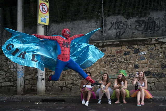 A person dressed in a Spider-Man costume strikes a pose at the “Ceu na Terra,” or Heaven on Earth, street party in Rio de Janeiro, on February 22, 2020. (Photo by Leo Correa/AP Photo)