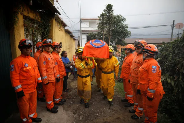 Rescuers carry the coffin of Juan Fernando Galindo, member of the National Coordinator for Disasters Reduction (CONRED), during his funeral in Alotenango, Guatemala June 5, 2018. According to CONRED executive director Sergio Cabanas, Galindo died while attempting to rescue people during the Fuego volcano eruption. (Photo by Jose Cabezas/Reuters)
