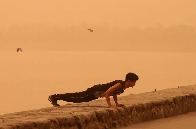 A man exercises amidst haze and dust near Sukhna lake in Chandigarh, India, June 15, 2018. (Photo by Ajay Verma/Reuters)