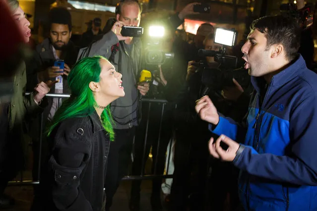 A protester argues with a supporter of Republican presidential nominee Donald Trump outside Trump Tower in New York City after midnight on election day November 9, 2016. Donald Trump stunned America and the world, riding a wave of populist resentment to defeat Hillary Clinton in the race to become the 45th president of the United States. The Republican mogul defeated his Democratic rival, plunging global markets into turmoil and casting the long-standing global political order, which hinges on Washington's leadership, into doubt. (Photo by Dominick Reuter/AFP Photo)