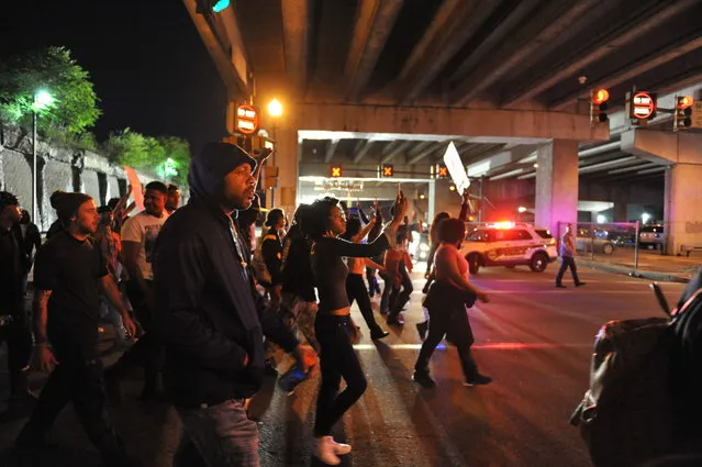 Protesters march down Sandusky Street towards PNC Park on the north side of Pittsburgh, Friday, June 22, 2018. Protesters demonstrated Friday for a third day over the fatal police shooting in Pennsylvania of an unarmed black teen, Antwon Rose Jr., fleeing a traffic stop as they sought to get the attention of a nation engrossed by the immigration debate, and to pressure officials to charge the officer. (Photo by Andrew Stein/Pittsburgh Post-Gazette via AP Photo)
