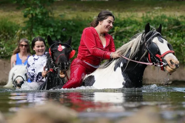 People ride their horses through the river during the Appleby Horse Fair, the annual gathering of gypsies and travellers in Appleby, Cumbria, UK on Thursday, June 8, 2023. (Photo by Owen Humphreys/PA Images via Getty Images)
