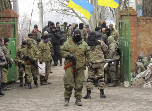 Members of the armed forces of Ukraine attend the funeral of a Ukrainian serviceman, who was killed while taking part in battles at the airport of Donetsk, in Mariupol, a city on the Sea of Azov, January 27, 2015. (Photo by Nikolai Ryabchenko/Reuters)