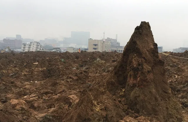 A mound of dirt forms in the aftermath of a landslide in Shenzhen in southern China's Guangdong province Monday, December 21, 2015. (Photo by Chinatopix via AP Photo)