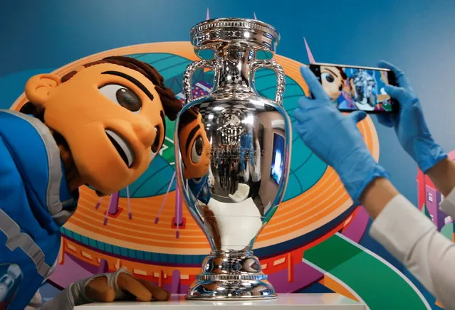 UEFA Euro 2020 mascot Skillzy poses with the trophy marking 100 days before the start of the Euro 2020 soccer tournament in St. Petersburg, Russia, March 3, 2021. (Photo by Anton Vaganov/Reuters)