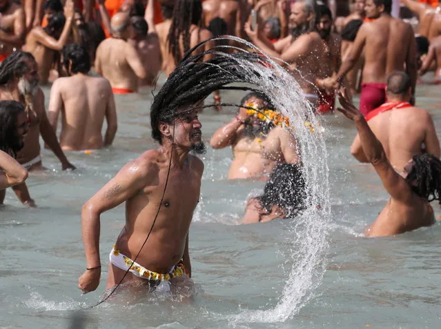 Naga Sadhus, or Hindu holy men, take a dip in the Ganges river during the first Shahi Snan at “Kumbh Mela”, or the Pitcher Festival, in Haridwar, India, March 11, 2021. (Photo by Anushree Fadnavis/Reuters)