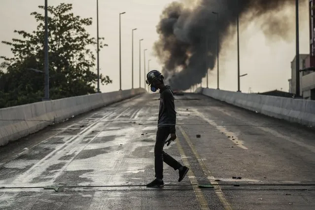 A demonstrator walks along a bridge during a protest against the military coup in Yangon, Myanmar, 17 March 2021. Anti-coup protests continue despite the intensifying violent crackdowns on demonstrators by security forces. (Photo by EPA/EFE/Stringer)