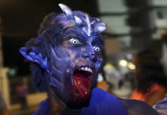 A masquerader from the Paramin Blue Devils parades before judges during the traditional mas competition held by the National Carnival Commission at Victoria Square, in the capital Port-of-Spain, February 12, 2015. (Photo by Andrea De Silva/Reuters)