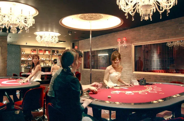 In this July, 2014, photo, restaurant guests enjoy Casino-style display at Jack & Queen restaurant in Osaka. Japan’s parliament has approved a contentious casino implementation law on Friday, July 20, 2018, clearing the way for casinos to open in this wealthy nation and possibly lure more foreign visitors. (Photo by Kyodo News via AP Photo)