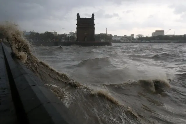 Waves caused by Cyclone Tauktae crash up on the promenade near the Gateway of India monument in Mumbai, India, May 17, 2021. (Photo by Niharika Kulkarni/Reuters)