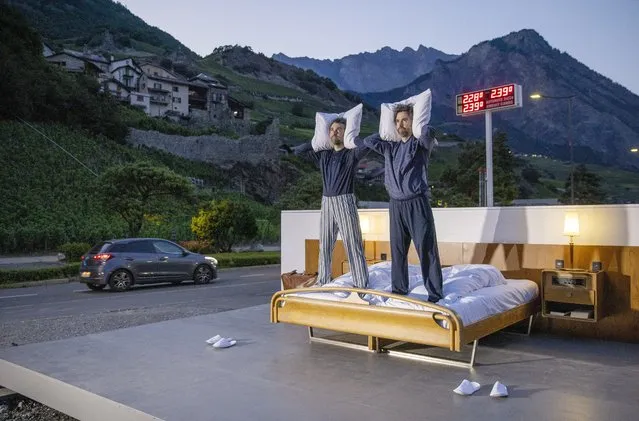 Swiss artists Frank and Patrik Riklin pose on the bed in the anti-idyllic suite of the Null-Stern-Hotel (Zero-Star-Hotel), offering guests a choice between four open-air rooms in reaction to the world current state after the pandemic, in Saillon, Switzerland on June 14, 2022. (Photo by Denis Balibouse/Reuters)