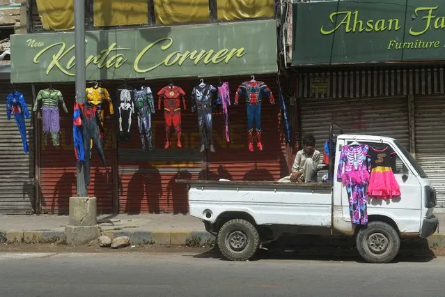 A costume vendor waits for customers outside the closed shops during a strike by traders, against the surge in electricity prices and inflation, in Karachi on September 1, 2023. (Photo by Asif Hassan/AFP Photo)