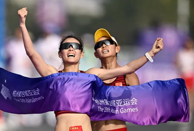 Yang Jiayu and Ma Zhenxia of Team China cross the finish line in the Athletics – Women's 20km Race Walk Final on day six of the 19th Asian Games at Smart New World Qiantang River Green Belt on September 29, 2023 in Hangzhou, Zhejiang Province of China. (Photo by Dylan Martinez/Reuters)