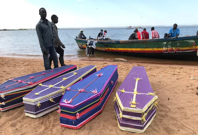 Volunteers arrange the coffins containing the dead bodies of passengers retrieved after a ferry MV Nyerere overturned off the shores of Ukara Island in Lake Victoria, Tanzania on September 22, 2018. (Photo by Jackson Njehia/Reuters)