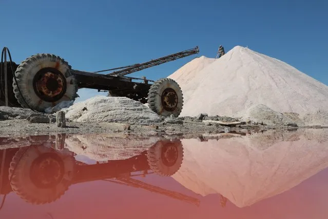 An employee works at a pink salt production site on Lake Sasyk-Sivash near Yevpatoria, on September 21, 2023. The rare mineral is colored by tiny algae that produce the pigment beta-carotene. (Photo by AFP Photo/Stringer)