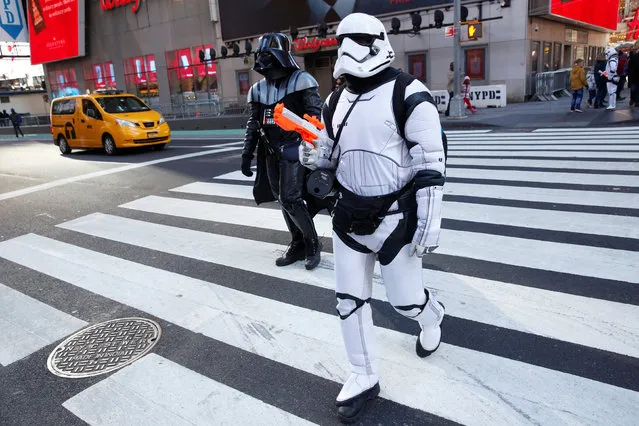 People dressed as Darth Vader and a Stormtrooper from Star Wars Rogue One walk in Times Square on Christmas Day in Manhattan, New York City, U.S., December 25, 2016. (Photo by Andrew Kelly/Reuters)