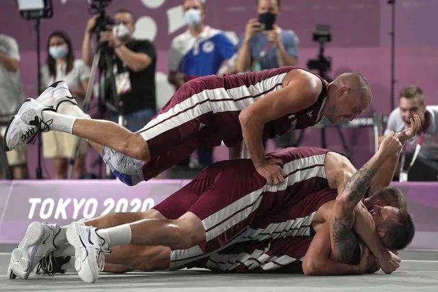 Members of team Latvia celebrate after defeating Russian Olympic Committee to win the men's 3-on-3 basketball gold medal at the 2020 Summer Olympics, Wednesday, July 28, 2021, in Tokyo, Japan. (Photo by Jeff Roberson/AP Photo)
