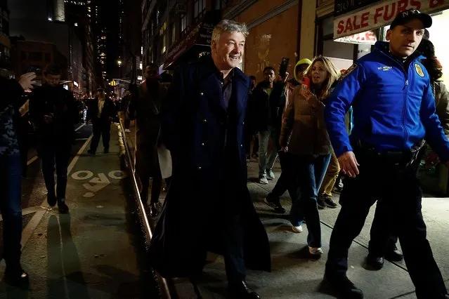 American actor Alec Baldwin is escorted away from a pro-Palestine protest by NYPD officers after clashing with protesters in Midtown Manhattan on December 18, 2023 in New York City. (Photo by John Lamparski/GC Images)