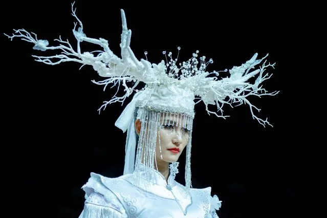 A model displays a creation from a collection by Jingyi Jin during China Fashion Week in Beijing on September 5, 2021. (Photo by Wang Zhao/AFP Photo)