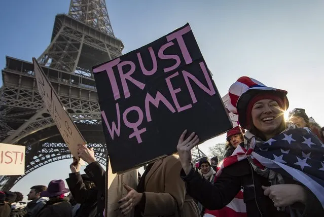 Protesters with an anti-Trump signs during the Women's March near the Eiffel Tower in Paris, France, 21 January 2017. Protest rallies were held in over 30 countries around the world in solidarity with the Women's March on Washington in defense of press freedom, women's and human rights following the official inauguration on 20 January of Donald J. Trump as the 45th President of the United States of America in Washington, USA. (Photo by Ian Langsdon/EPA)