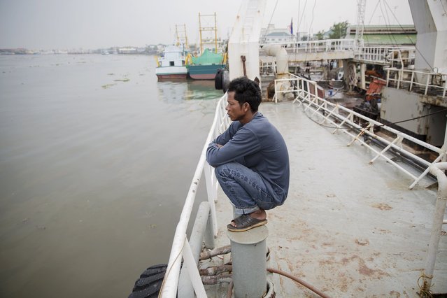 A man looks from a large fishing ship that just returned after 24 months out at sea, at a port in Mahachai, in Thailand's Samut Sakhon province April 23, 2015. (Photo by Damir Sagolj/Reuters)