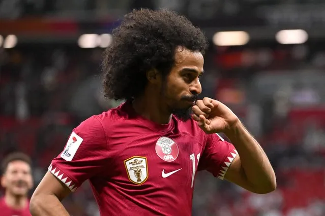 Qatar's forward #11 Akram Afif celebrates after scoring his team's first goal during the Qatar 2023 AFC Asian Cup Group A football match between Tajikistan and Qatar at the Al-Bayt Stadium in Al Khor, north of Doha on January 17, 2024. (Photo by Hector Retamal/AFP Photo)