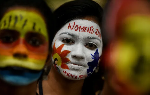 Indian students pose with their faces painted on the occasion of International Women's Day celebration at a college in Chennai on March 8, 2019. (Photo by Arun Sankar/AFP Photo)