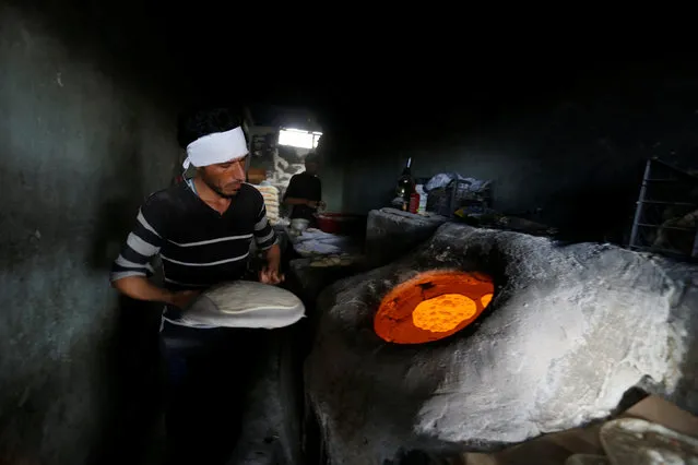 A man works in his bakery in Qayyara, south of Mosul, Iraq, January 28, 2017. (Photo by Muhammad Hamed/Reuters)