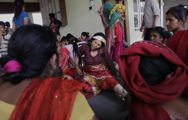 Nepalese villagers injured in Saturday's earthquake await evacuation at Trishuli Bazar in Nepal, Monday, April 27, 2015. (Photo by Altaf Qadri/AP Photo)