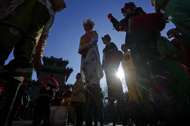 Chinese performers dressed in traditional costumes wait to participate in a performance at the Dongyue Temple during the first day of the Chinese Lunar New Year in Beijing, Saturday, February 10, 2024. (Photo by Andy Wong/AP Photo)