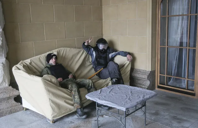 Protesters relax at the Ukrainian President Yanukovych's countryside residence in Mezhyhirya, Kiev's region, Ukraine, Saturday, February 22, 2014. (Photo by Efrem Lukatsky/AP Photo)