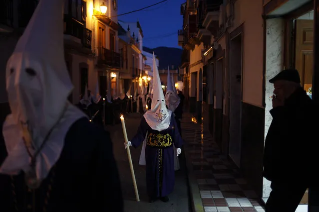 Penitents of the Cautivo brotherhood take part in a procession at dawn during Holy Week in Arriate, near Malaga, southern Spain, March 24, 2016. (Photo by Jon Nazca/Reuters)