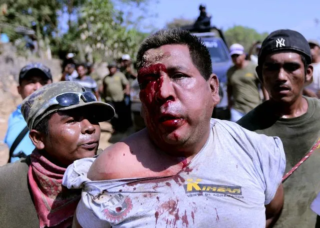 Community policemen arrest one of the seven alleged killers of another community policeman at the Parotillas village in Acapulco, Mexico, on April 4, 2014. (Photo by Pedro Pardo/AFP Photo)