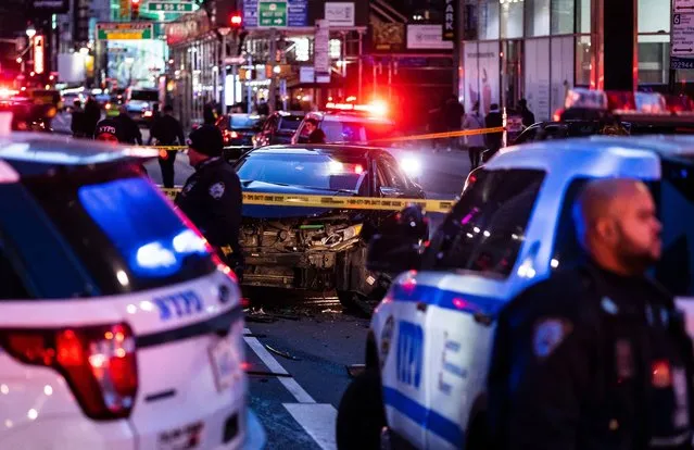 New York City police officers on the scene of a suspected carjacking on Broadway north of Times Square in New York, New York, USA, 12 January 2022. According to New York City Police Department statistics, New York City saw a five percent increase in major crimes in 2021, a trend found in many large cities around the United States. (Photo by Justin Lane/EPA/EFE)