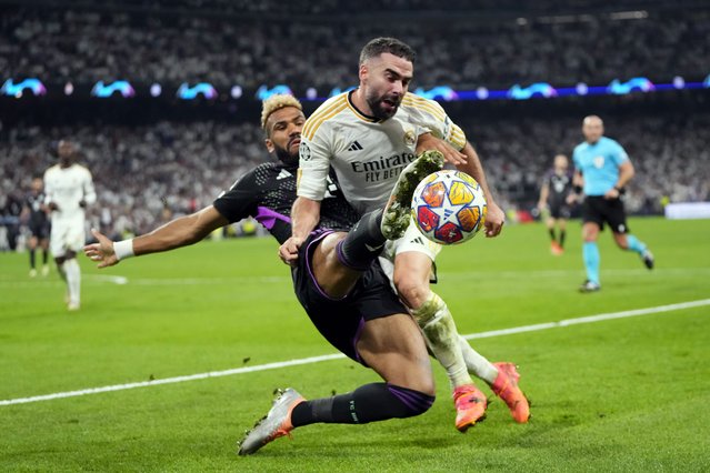 Bayern's Eric Maxim Choupo-Moting, left, fights for the ball with Real Madrid's Dani Carvajal during the Champions League semifinal second leg soccer match between Real Madrid and Bayern Munich at the Santiago Bernabeu stadium in Madrid, Spain, Wednesday, May 8, 2024. (Photo by Manu Fernandez/AP Photo)
