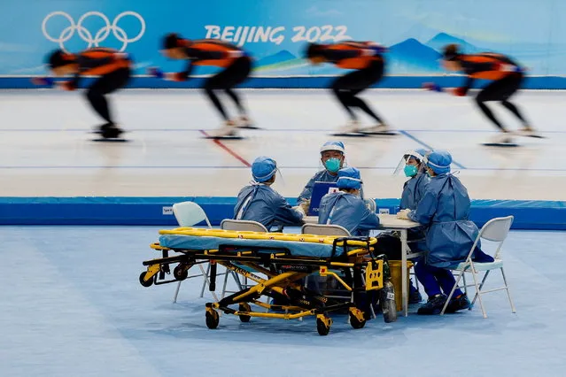 Medical staff in personal protective equipment are seen at a speed skating training session for the Beijing 2022 Winter Olympics in Beijing, China on January 28, 2022. (Photo by Tyrone Siu/Reuters)