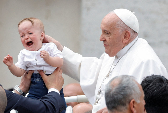 Pope Francis blesses a child on the day of the weekly general audience, in St. Peter's Square at the Vatican, on May 8, 2024. (Photo by Ciro de Luca/Reuters)
