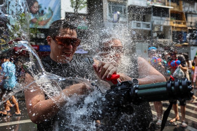 Tourists play with water as they celebrate the Songkran holiday which marks the Thai New Year in Bangkok, Thailand, on April 13, 2024. (Photo by Chalinee Thirasupa/Reuters)